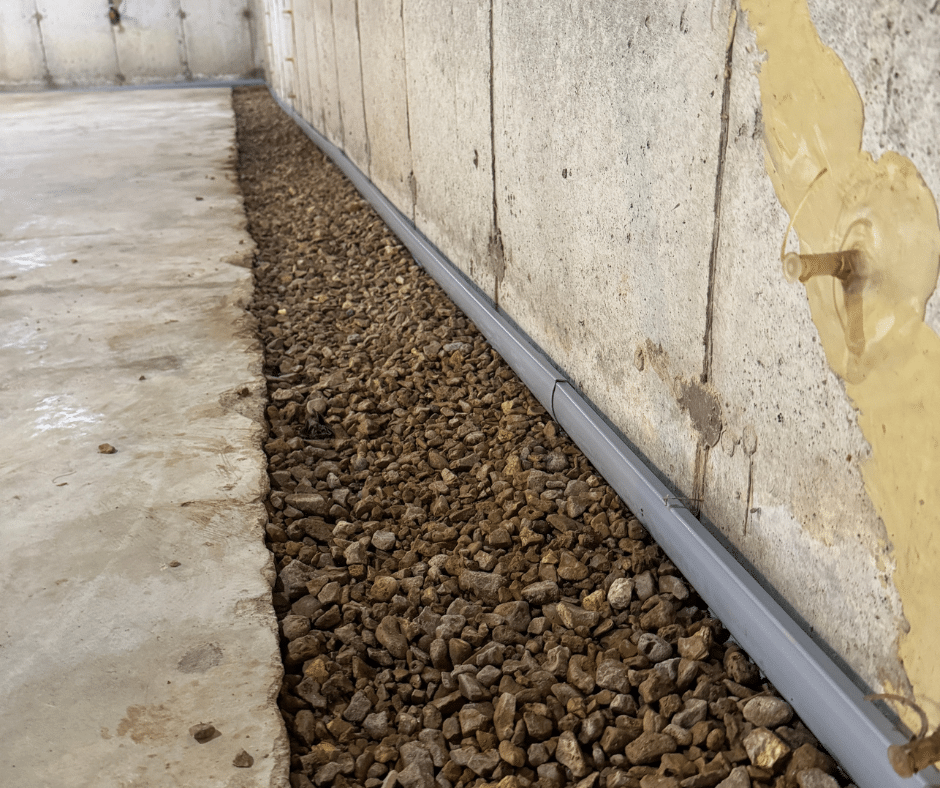 Drainage stone placed around the pipe to improve water collection and flow.